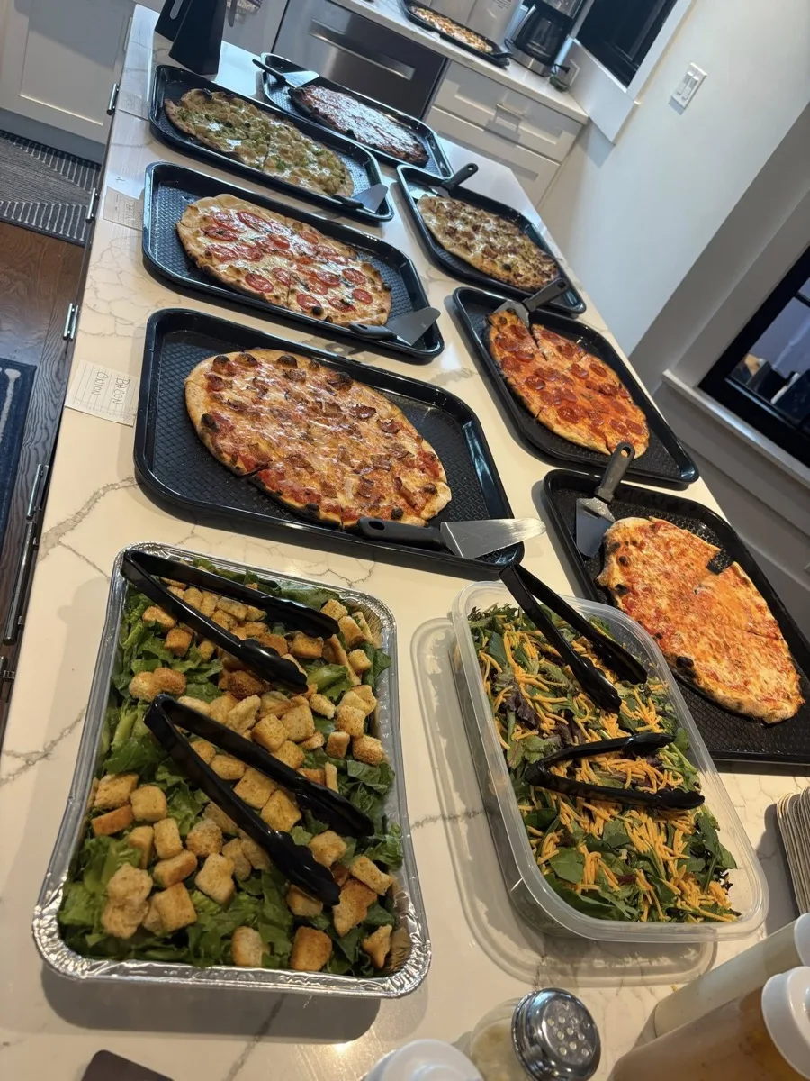 Full pizza party catering layout with wood fired pies and fresh salads in Guilford CT