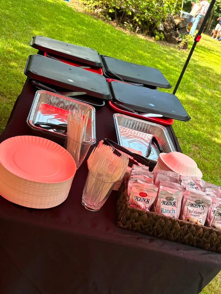 Plates, utensils and dressings set out for full service pizza party catering in Connecticut