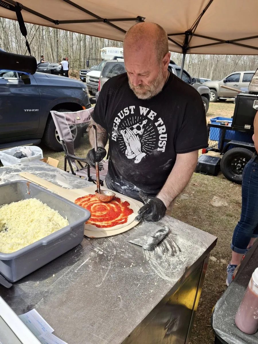 Rollin Dough pizza maker hand-stretching dough for wood fired apizza in Guilford CT