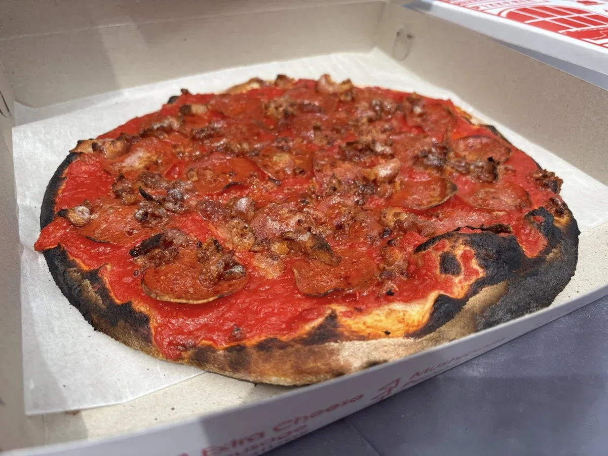 New Haven style wood fired apizza with charred crust from Rollin Dough pizza trailer