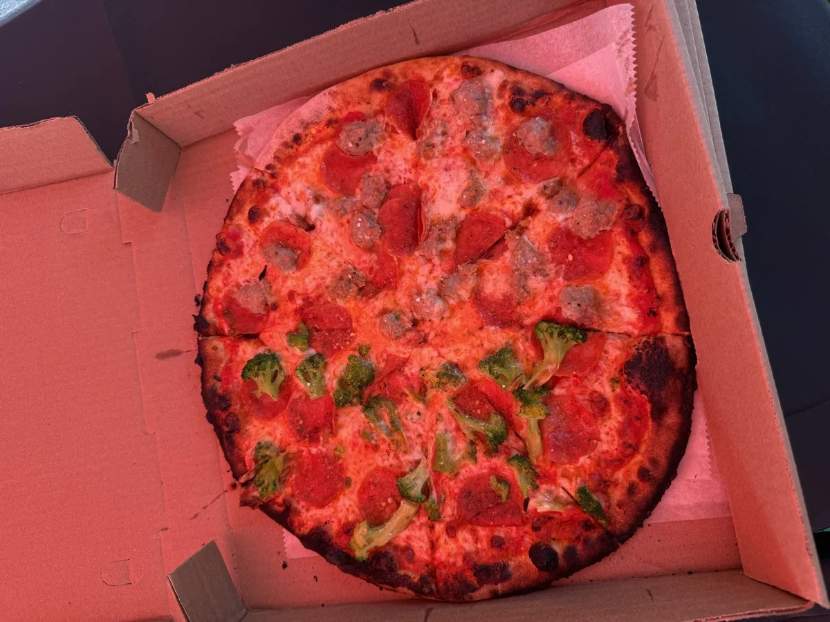 Wood fired apizza with pepperoni, sausage and broccoli from Rollin Dough mobile pizza catering Connecticut