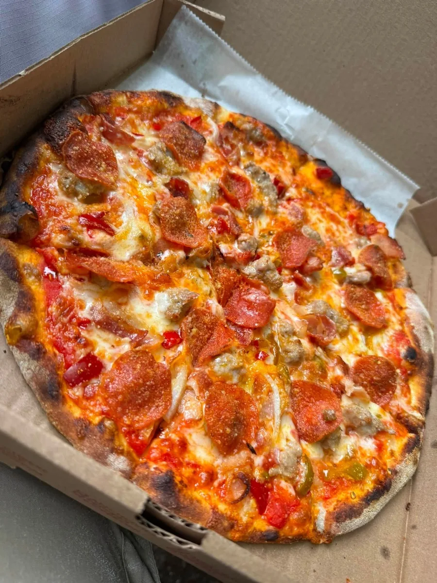 Pepperoni, sausage and pepper wood fired apizza from Rollin Dough mobile trailer in Guilford CT