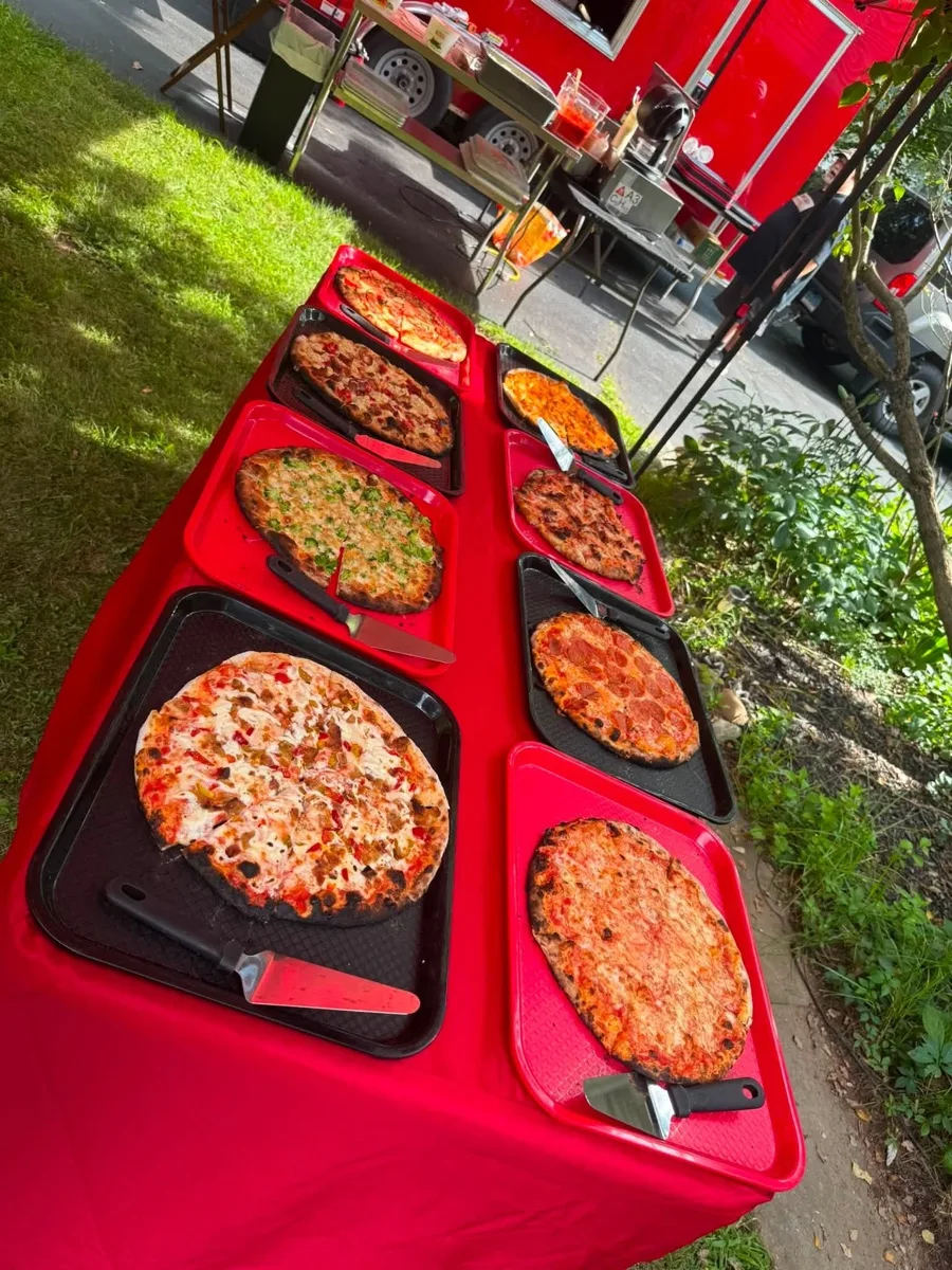 All you can eat wood fired apizza laid out buffet style at a Rollin Dough catering event in Connecticut
