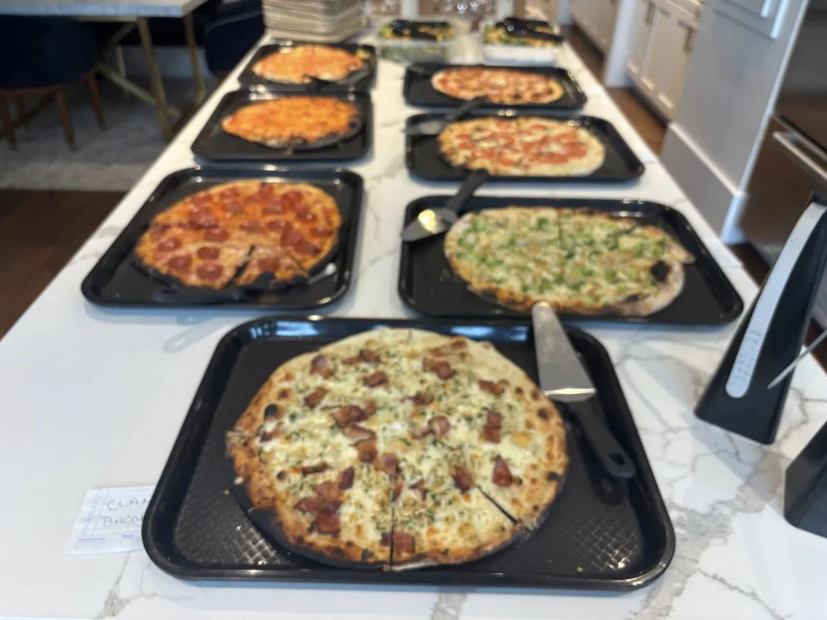 Rollin Dough pizza truck catering spread with multiple wood fired pizzas at Connecticut event