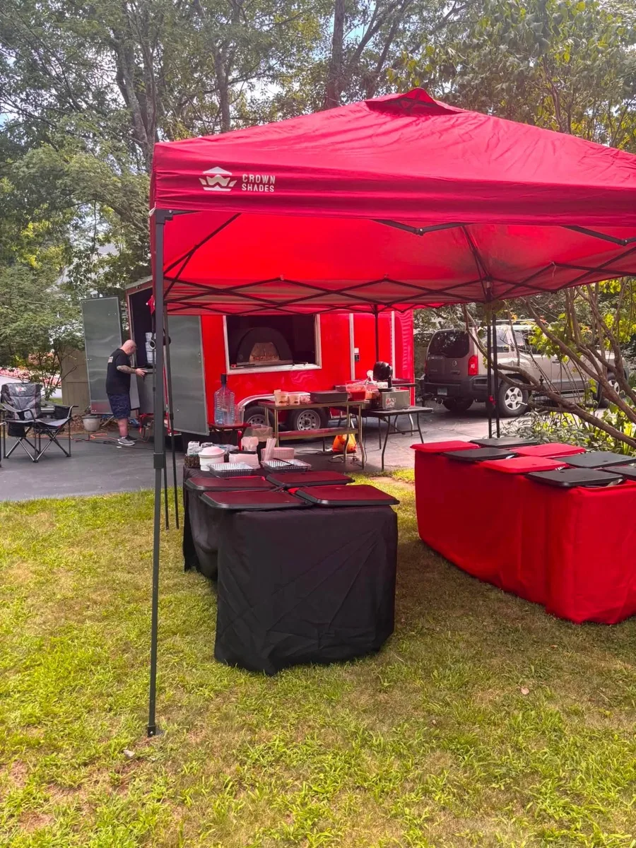 Rollin Dough mobile pizza trailer and catering tent set up for a backyard party in Connecticut