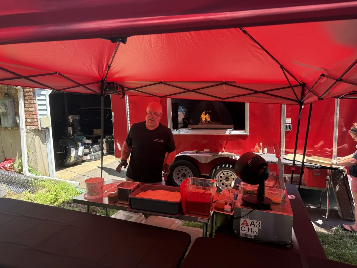 Barry Nuzzo working the prep line with the wood fired oven burning in Guilford CT