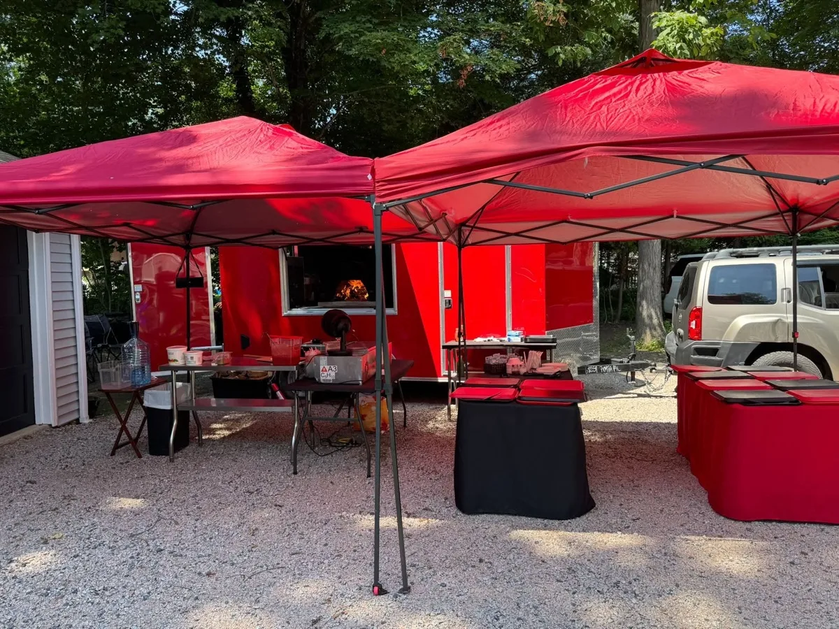 Rollin Dough wood fired pizza trailer with catering tents set up for a Connecticut event